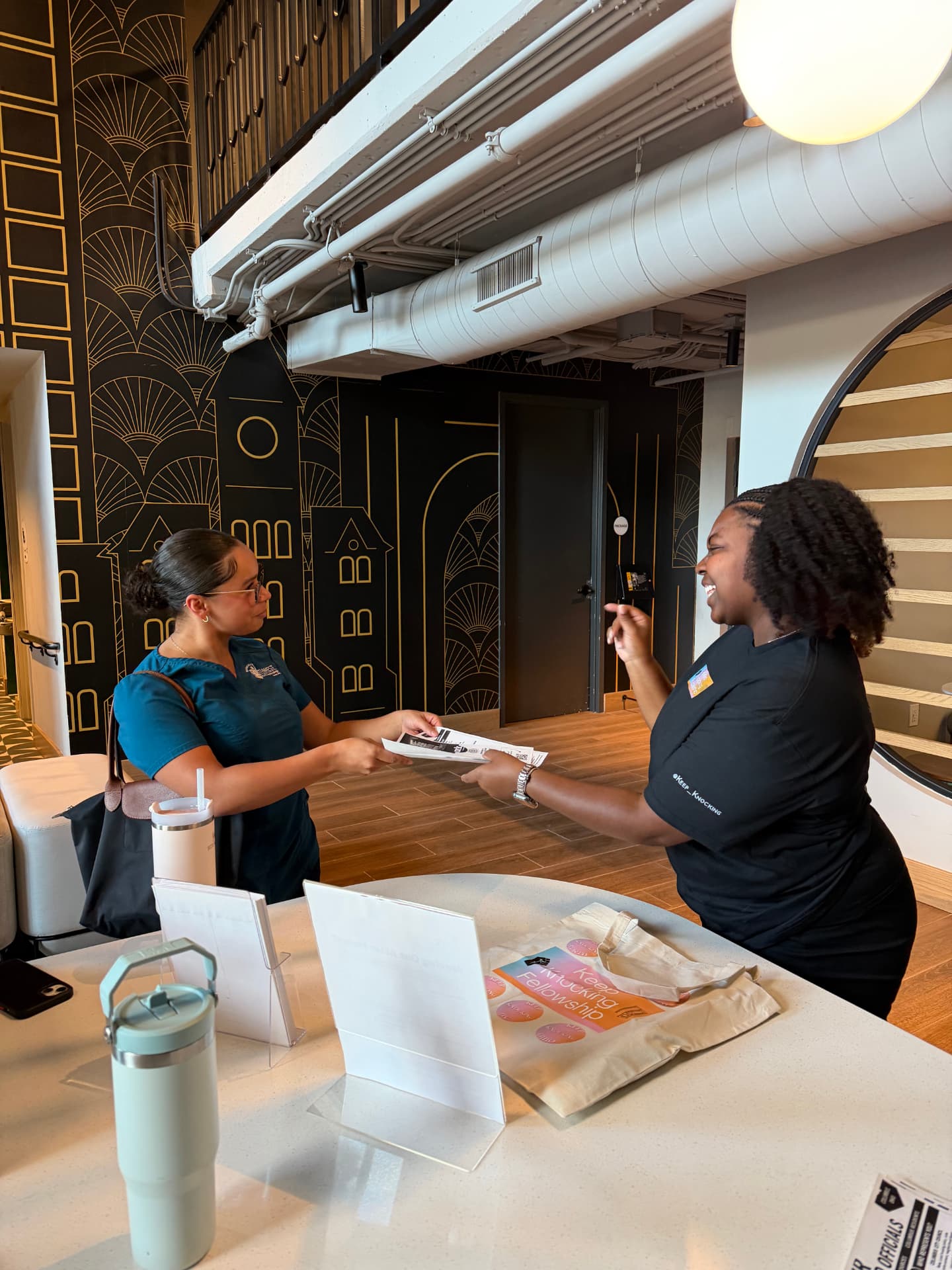 Fellow talking with a resident at an apartment leasing desk about housing rights