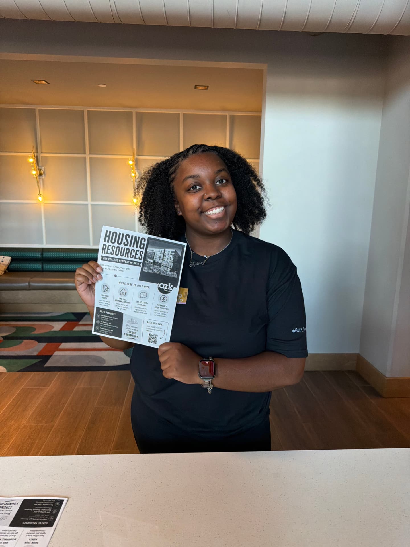 Keep Knocking fellow holding a Housing Resources flyer for college renters in Ohio